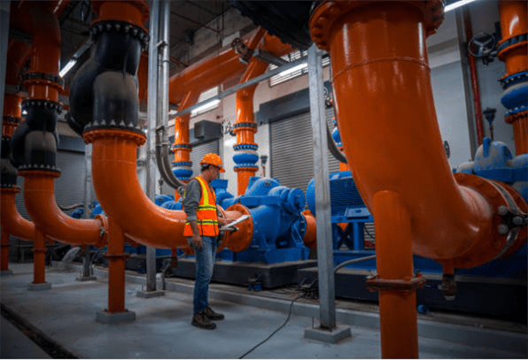 an engineer is checking industrial cooling tower of air conditioner